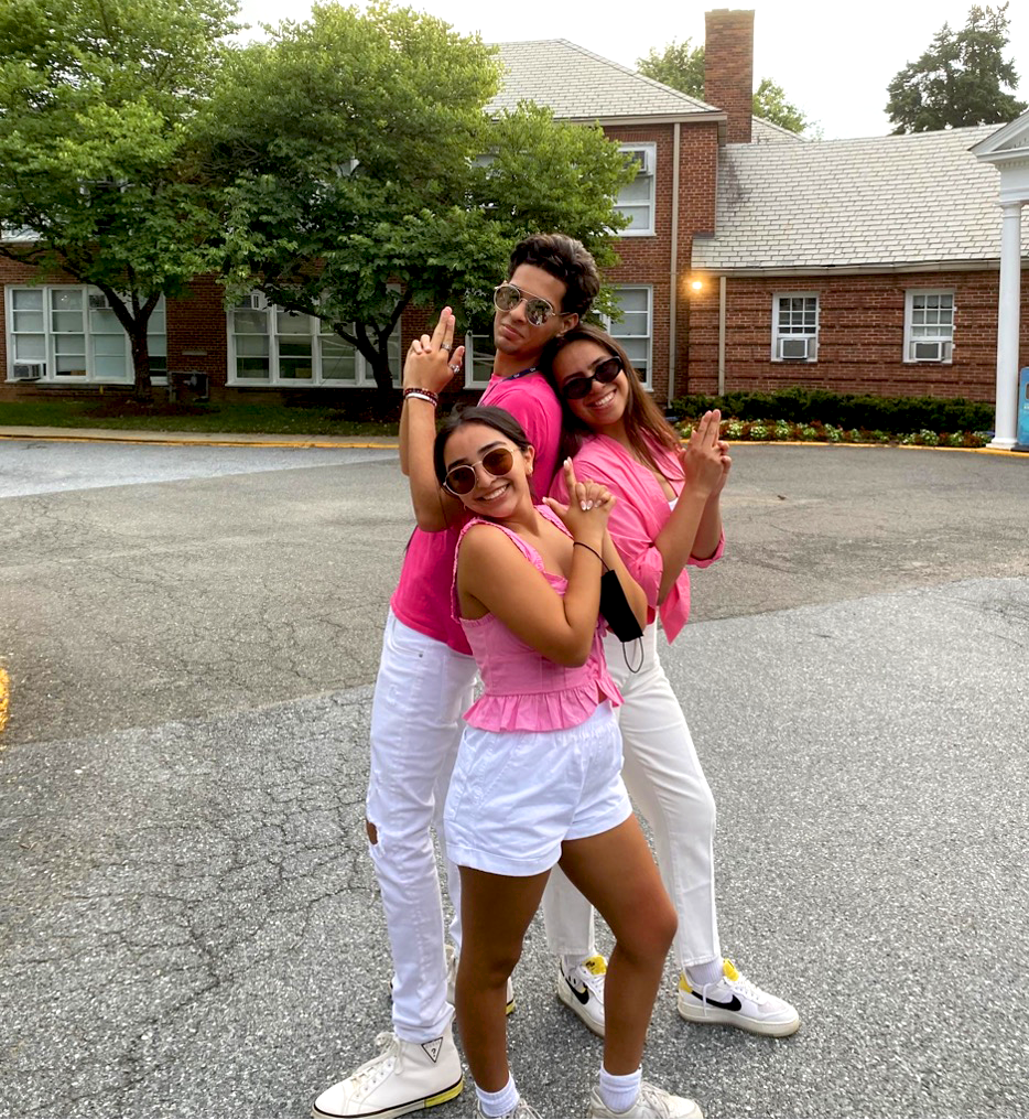 Three people in front of building