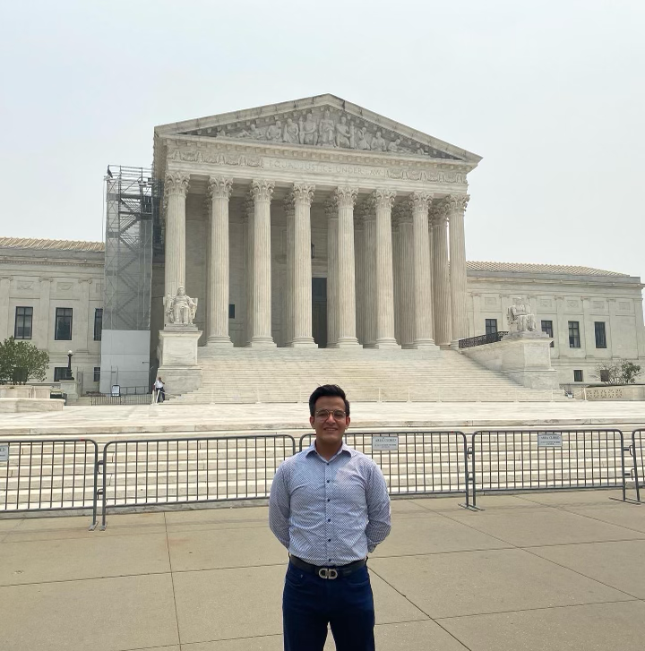 Student standing in front of the Supreme Court
