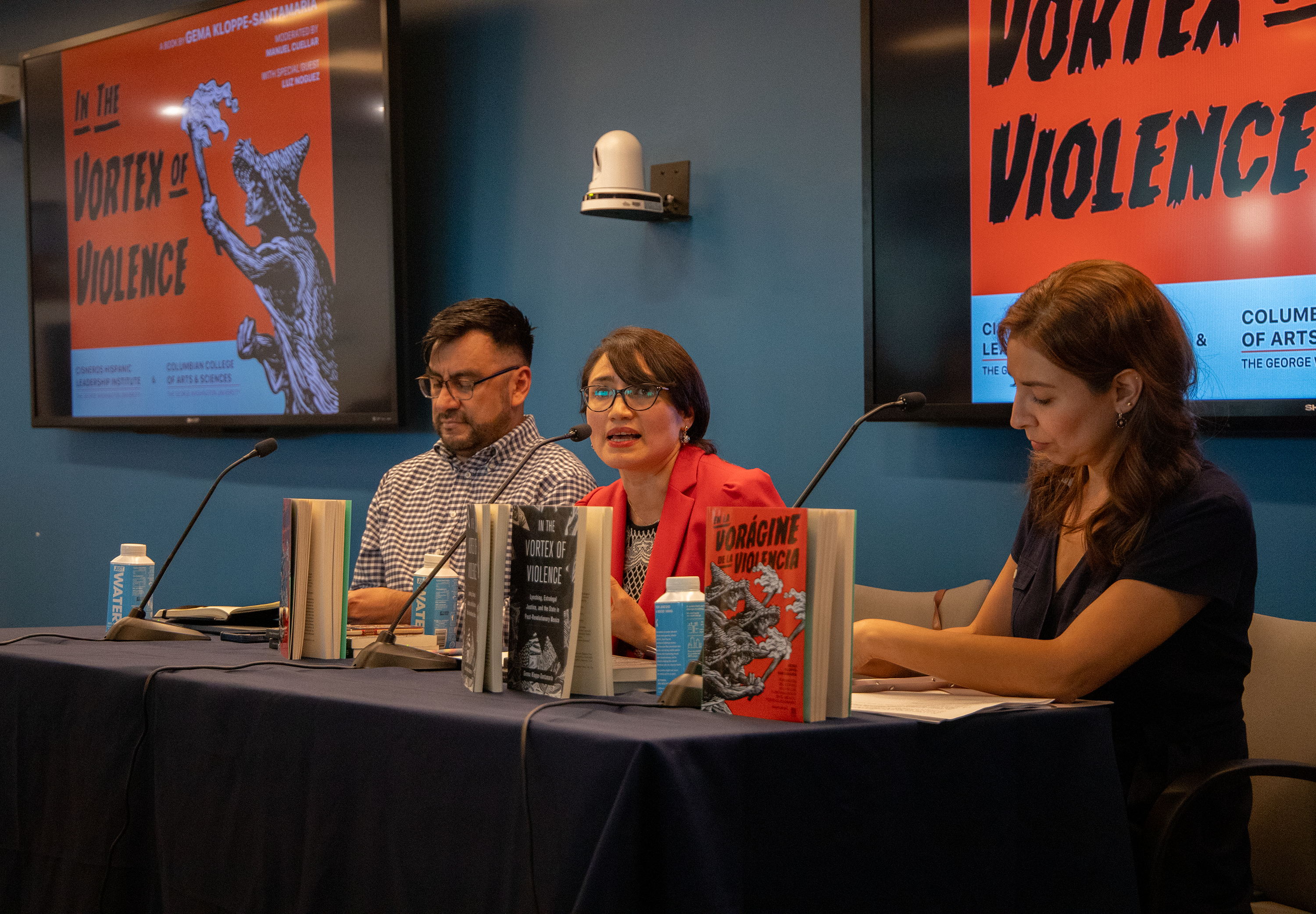 Three individuals sitting on a panel