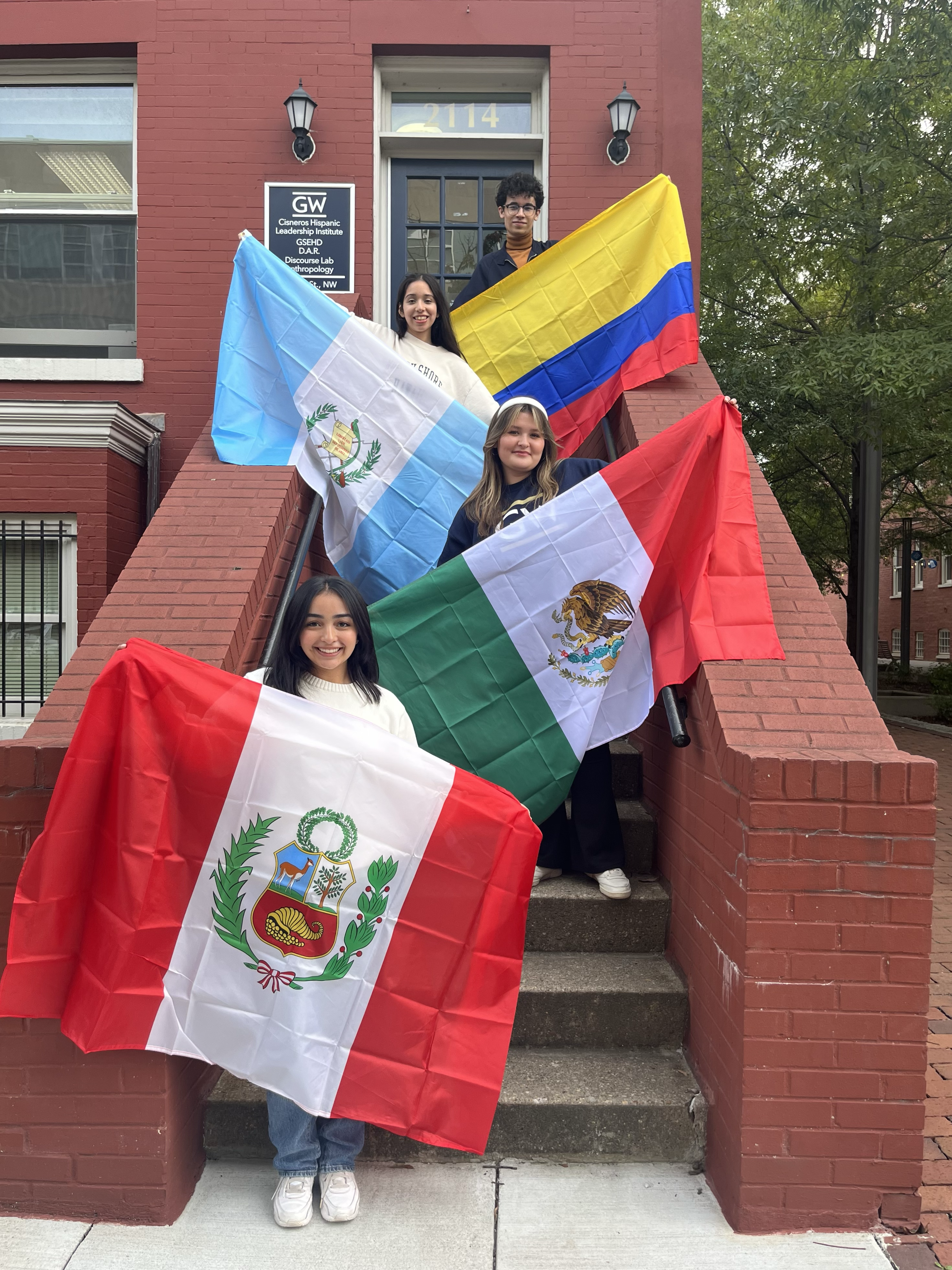 Four students holding up flags