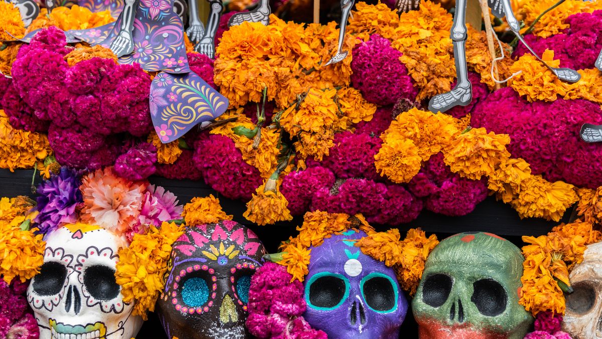 flowers and skulls on alter for day of the dead