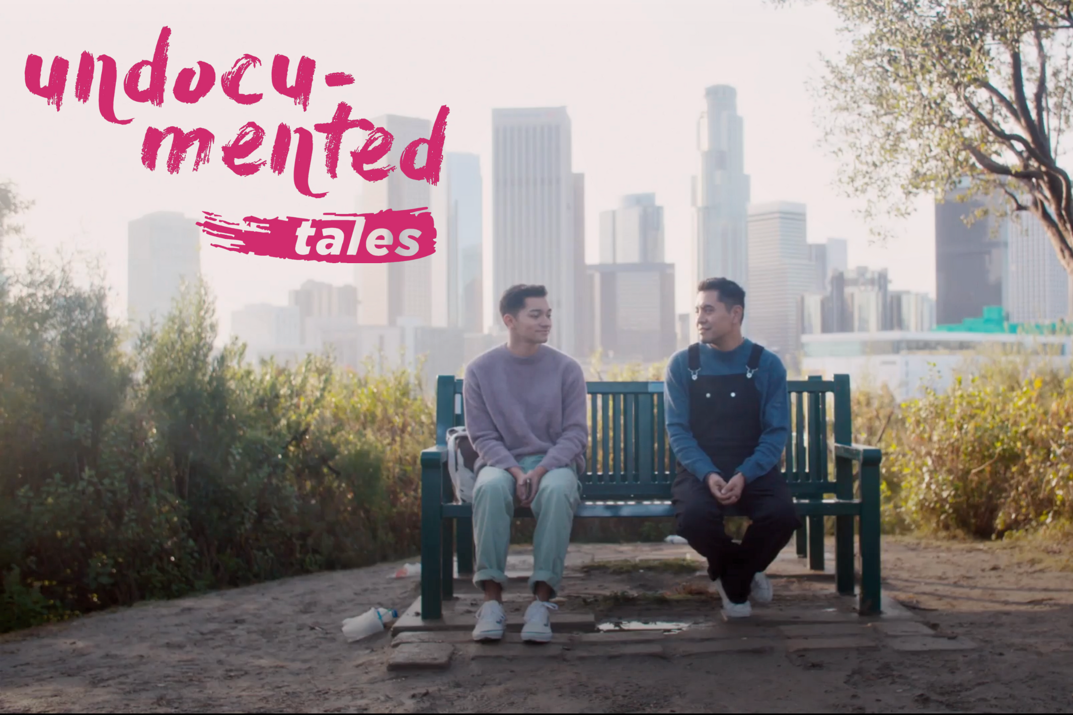 "Undocumented Tales" on the upper left with two men sitting on a bench