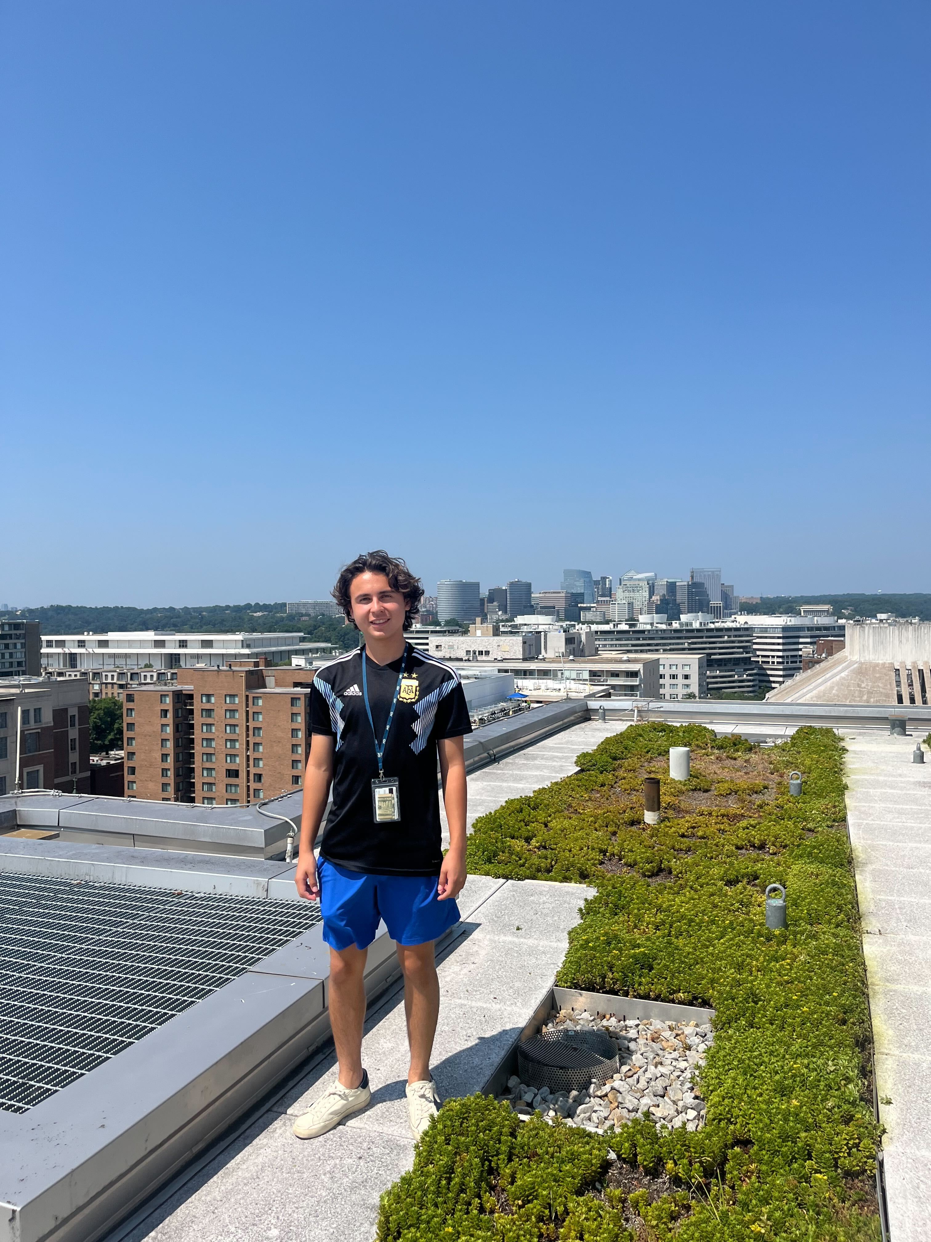 Student posing with the skyline behind them