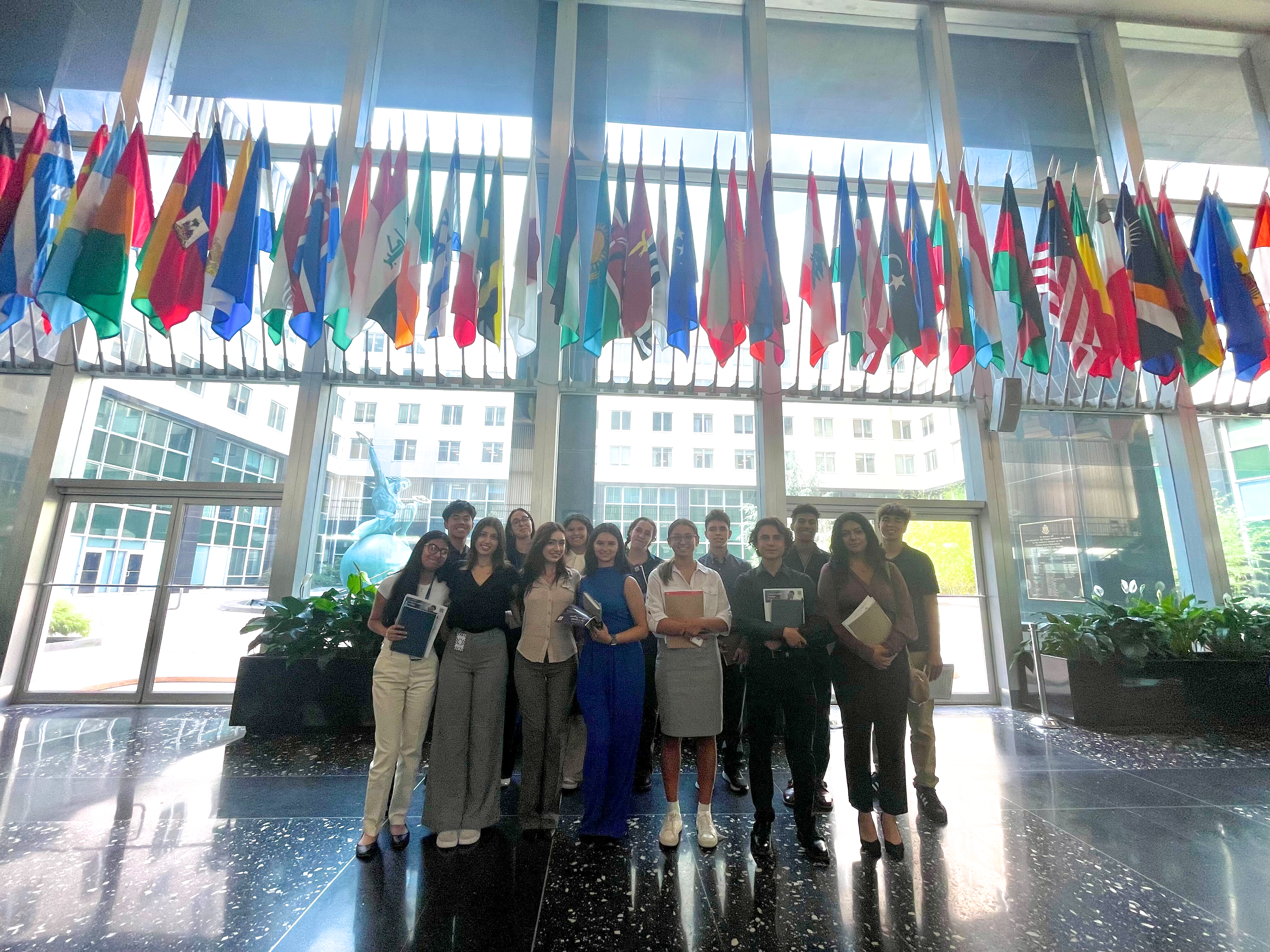 Group of students standing in front of flags