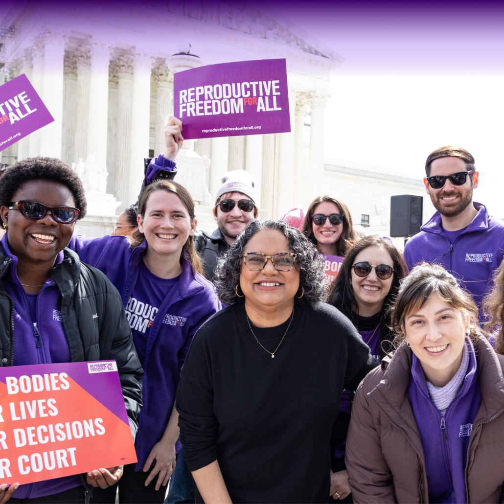 People standing in front of Supreme Court with sign that reads, "Reproductive Freedom for All"