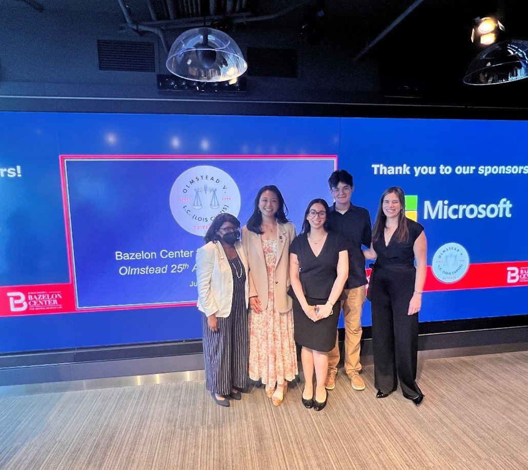 Group standing in front of a screen