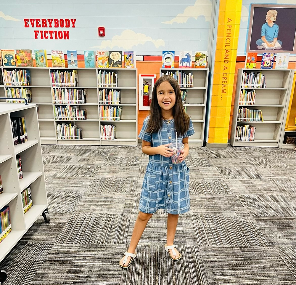 Young student in front of books