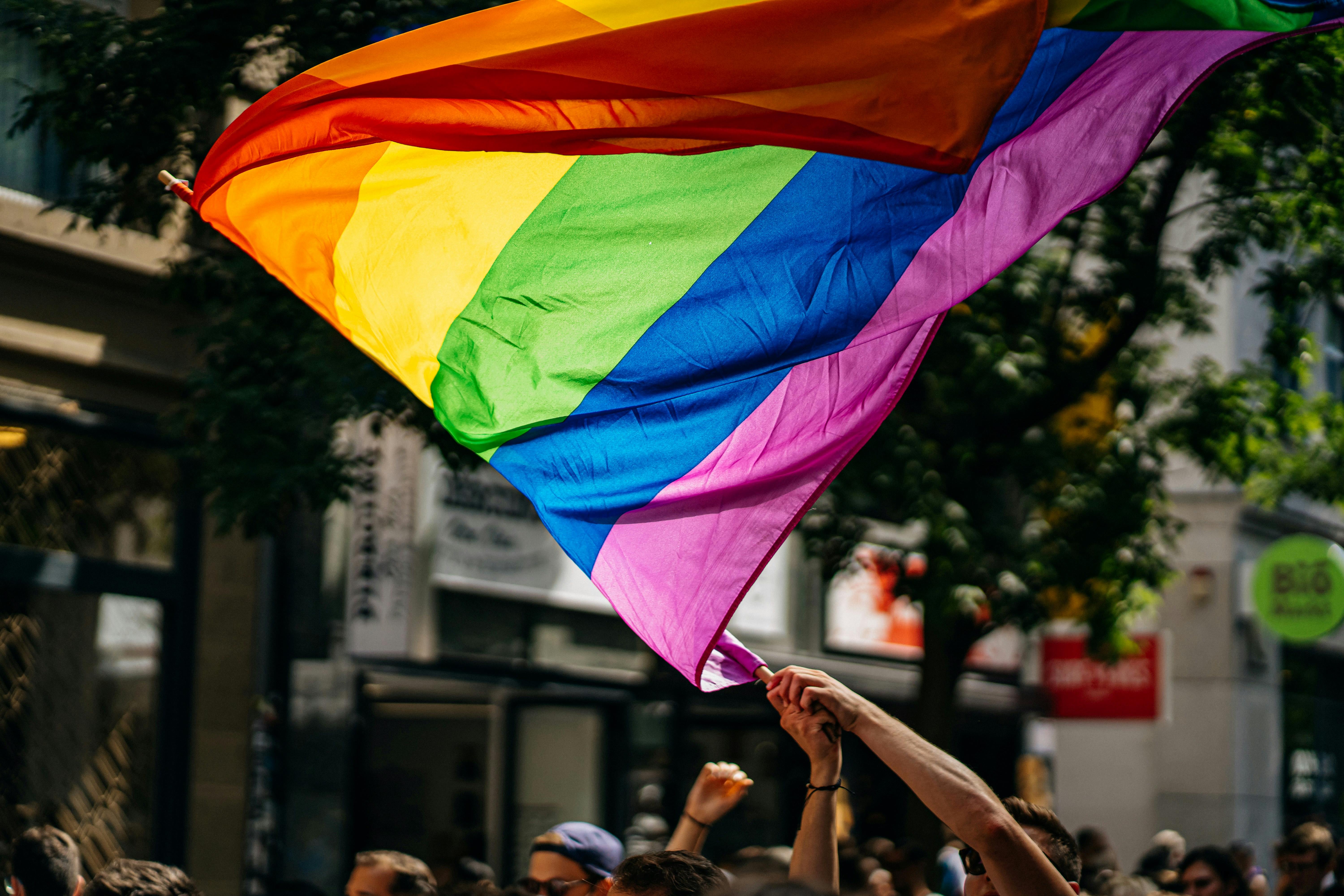Pride flag waved by unseen person
