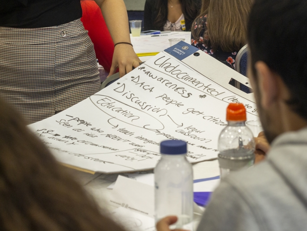 Big paper with words written on it: Undocumented, DACA, Awareness, Discussion, Education