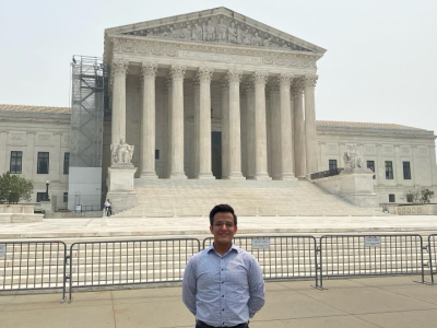 Student standing in front of the Supreme Court