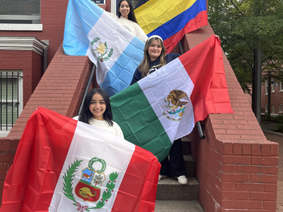 Four students holding up flags