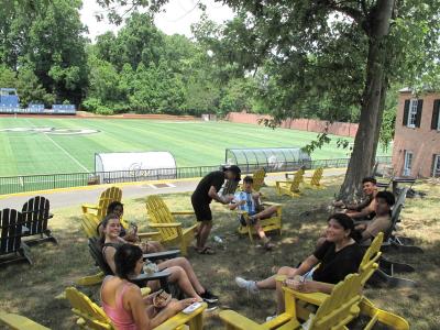 Students sitting in chairs in a field