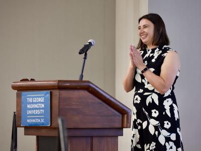 Individual speaking at the podium