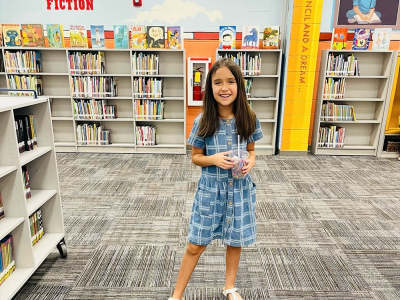 Young student in front of books
