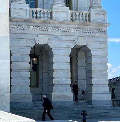Side of the Senate building with Bernie Sanders walking