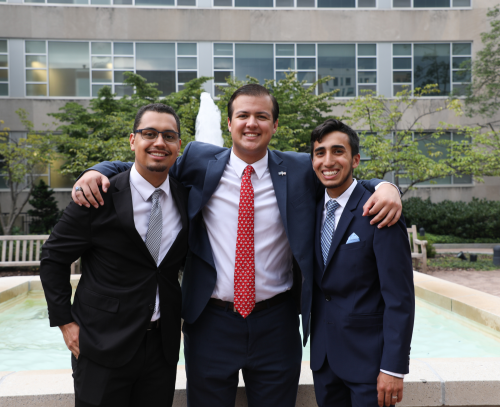 three students smiling