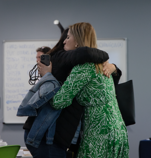Two women hug