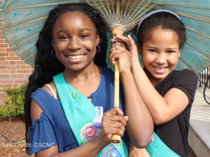 Two young girls smiling at camera