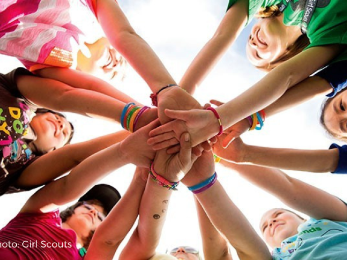 Group of students putting their hands together