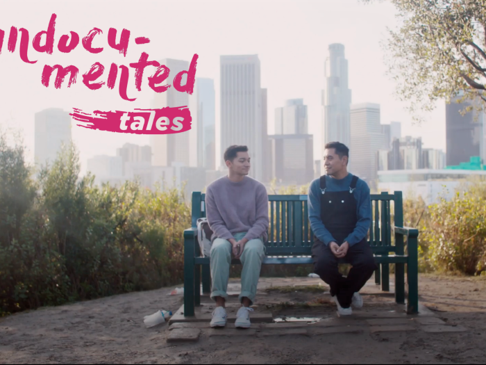 "Undocumented Tales" on the upper left with two men sitting on a bench