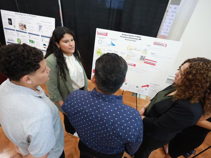 Student presenting posters