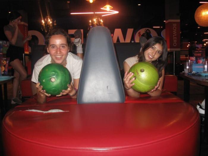 Two people holding bowling balls