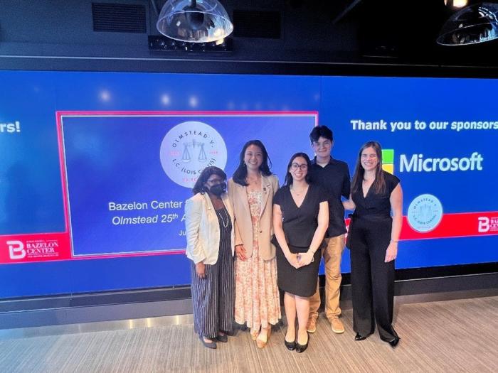 Group standing in front of a screen