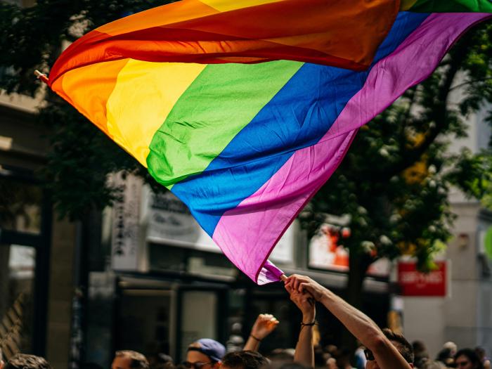 Pride flag waved by unseen person