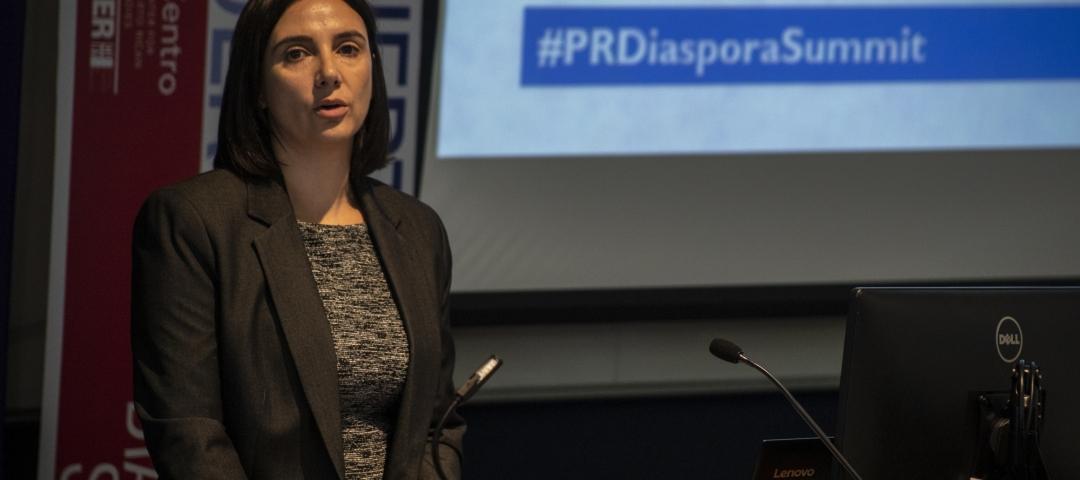 Dr. Elizabeth Vaquera speaks at a lectern in front of a presentation slide that reads #PRDiversitySummit