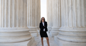 Student standing around columns