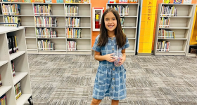 Young student in front of books